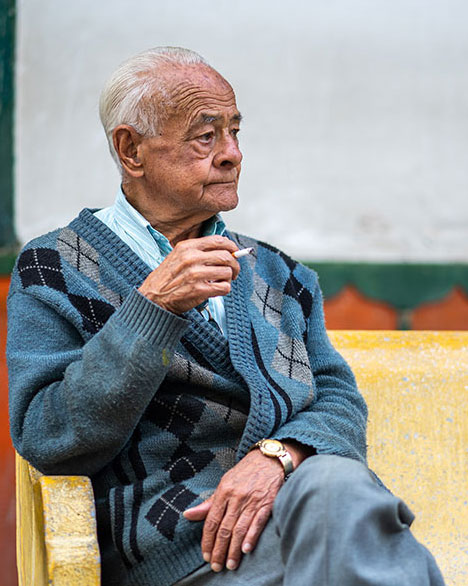 Elderly Man Sitting with a Cigarette